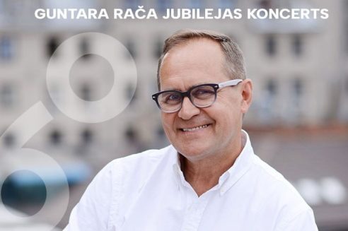 Guntars Račs smaidot raugās kamerā, valkājot brilles un baltu kreklu. Attēlā redzams teksts "GUNTARA RAČA JUBILEJAS KONCERTS" un liels, daļēji caurspīdīgs skaitlis "60".